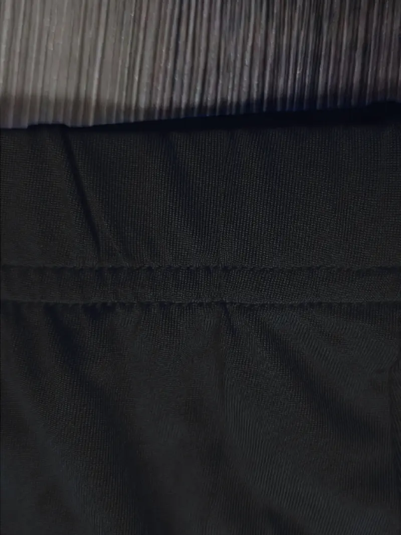 Close-up of the black stretchy fabric used in women's floral cut-out shorts set