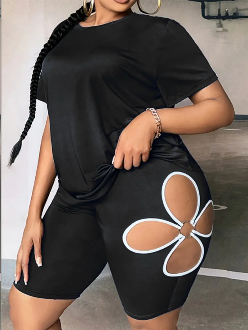 Front view of black women's floral cut-out shorts set